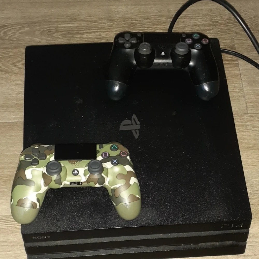 Sony Console with Black and Camouflage Controllers